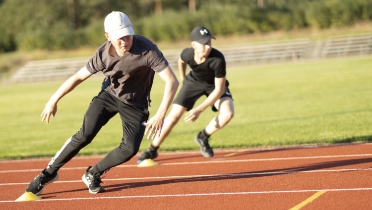 Two guys doing excercises on track